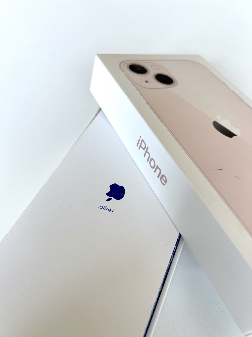 The folded manual tucked under an iPhone box lid, where the usual leaflet would be